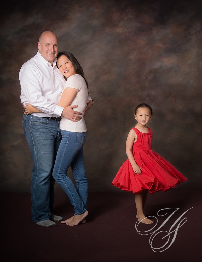 A man and woman standing next to a little girl.
