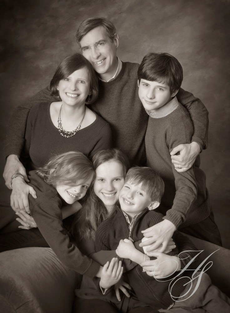 A family posing for a picture in black and white.