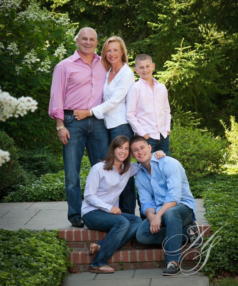A family posing for a picture in the garden.
