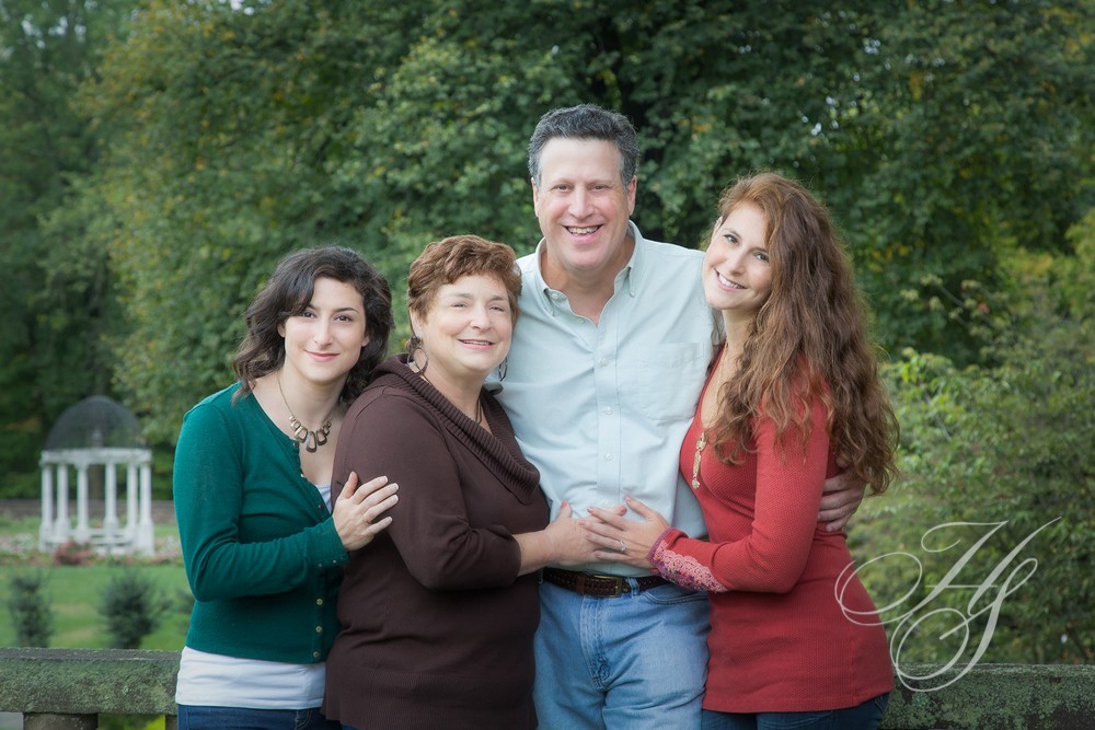 A family posing for a picture in the park.
