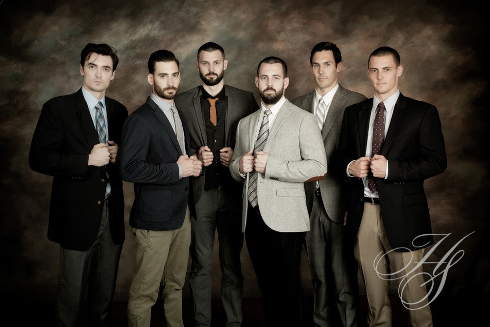 A group of men in suits and ties posing for the camera.