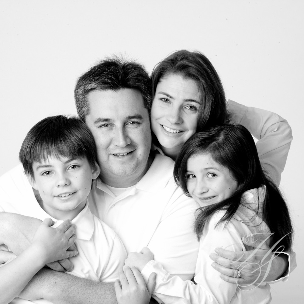A family posing for a picture in black and white.