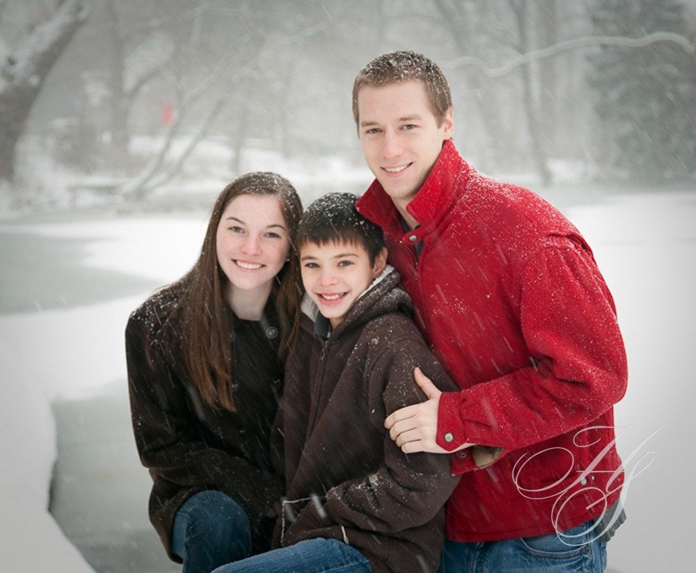 A family posing for a picture in the snow.