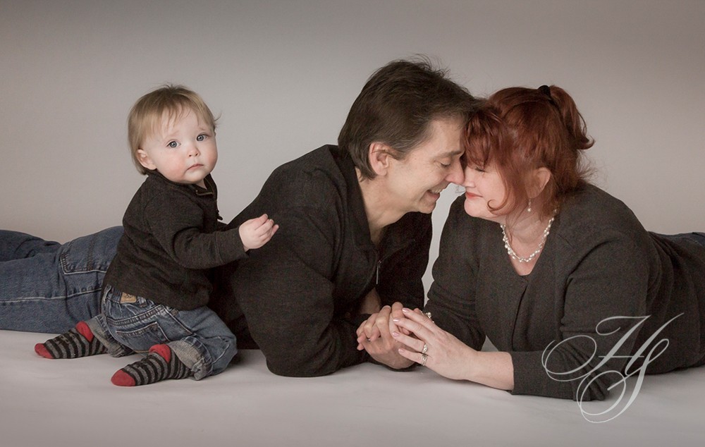 A couple of people and a baby are sitting on the ground