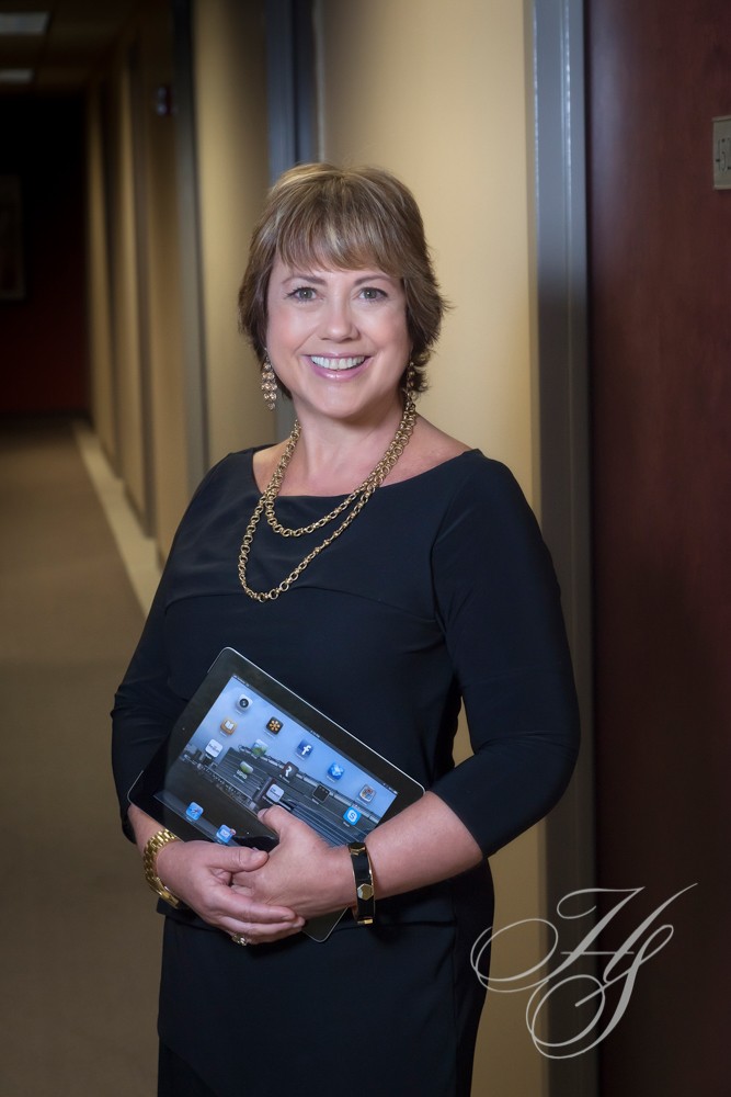A woman holding an ipad in her hands.