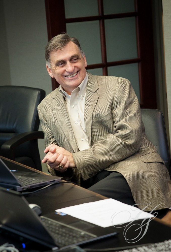 A man sitting at a table with a laptop.