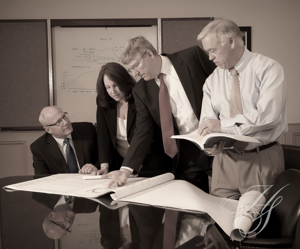 A group of people standing around a table.