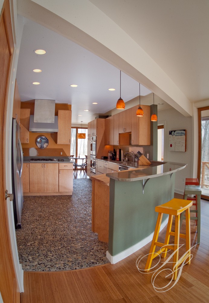 A kitchen with a yellow stool and a counter