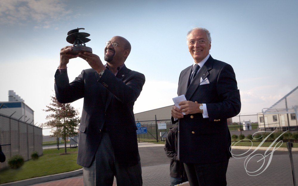 Two men in suits and ties standing next to each other.