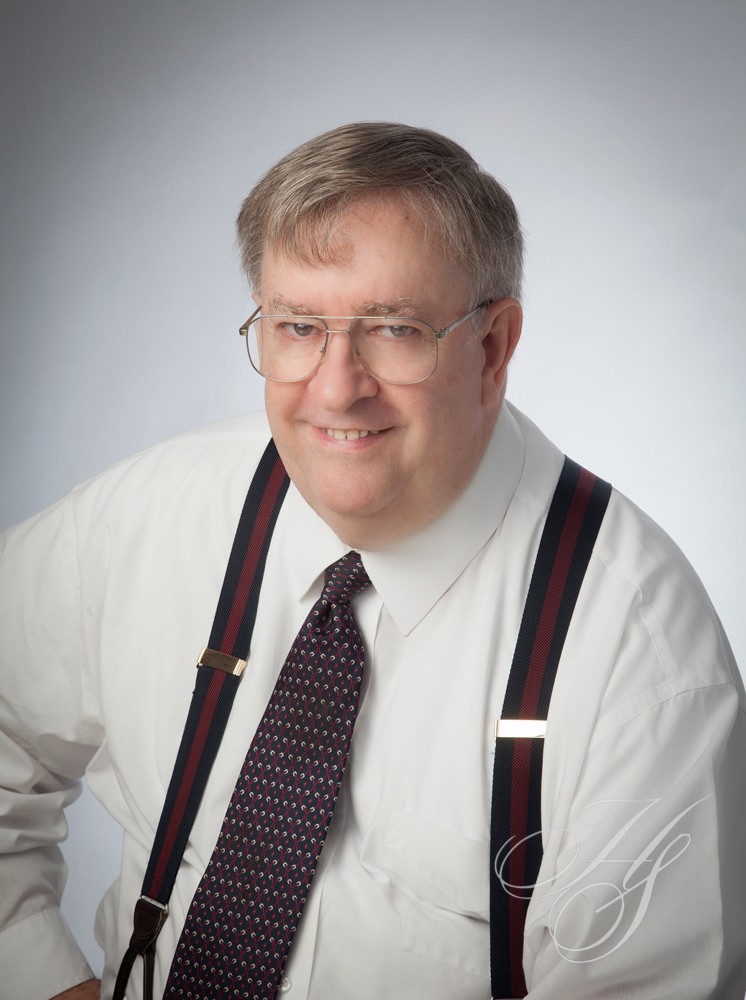 A man wearing glasses and a tie.