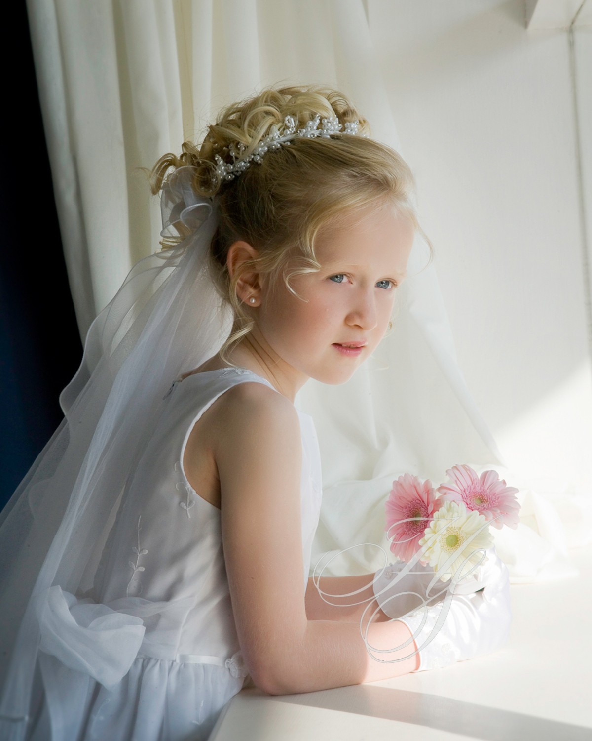 A young girl in her first communion dress.