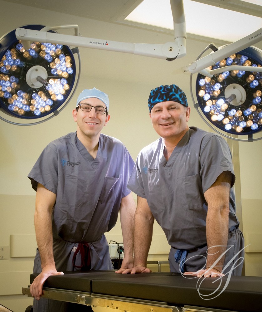Two men in scrubs standing next to each other.