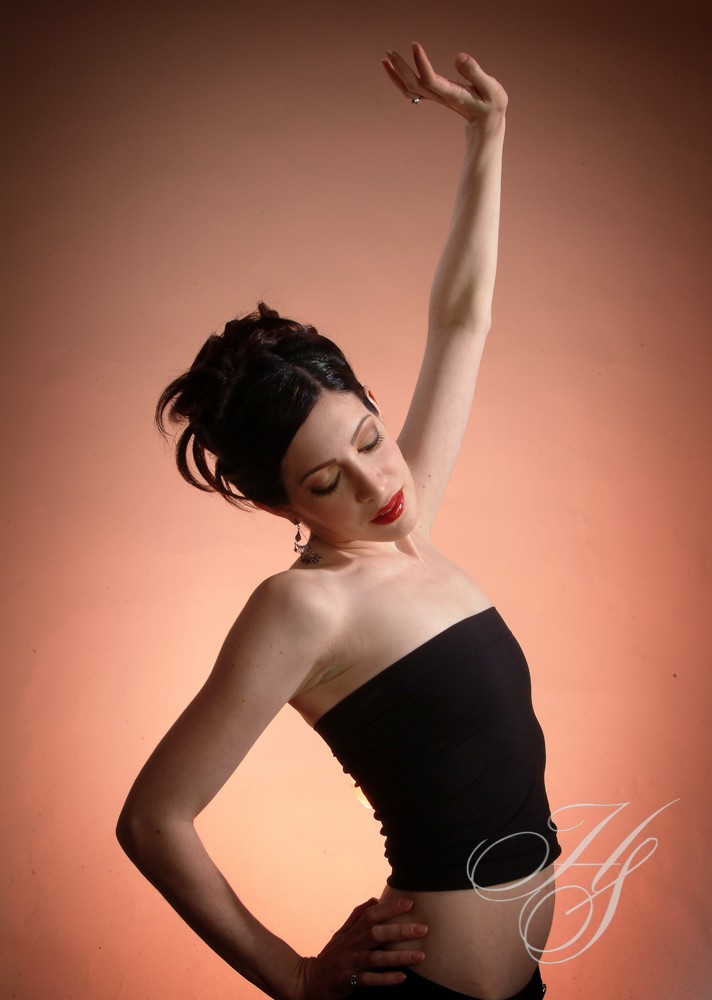 A woman in black dress posing for the camera.