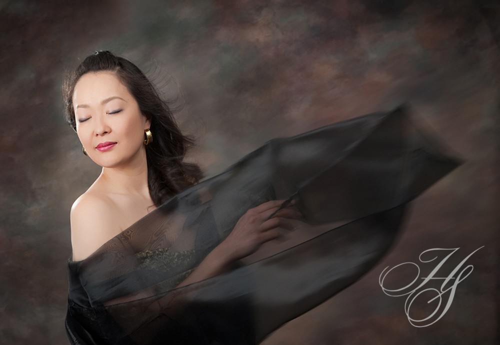 A woman in black dress with long hair.