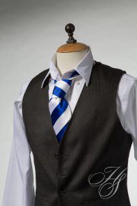 A suit and tie with a blue striped neck tie.