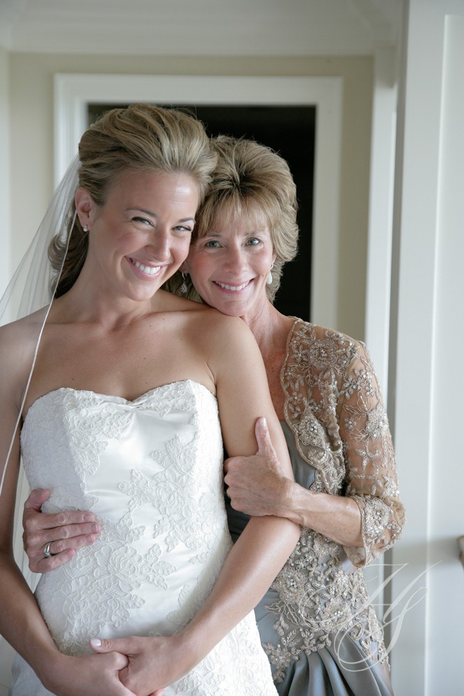 A bride and her mother posing for the camera.