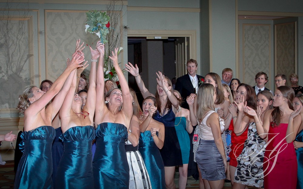 A group of people in dresses holding up their hands.