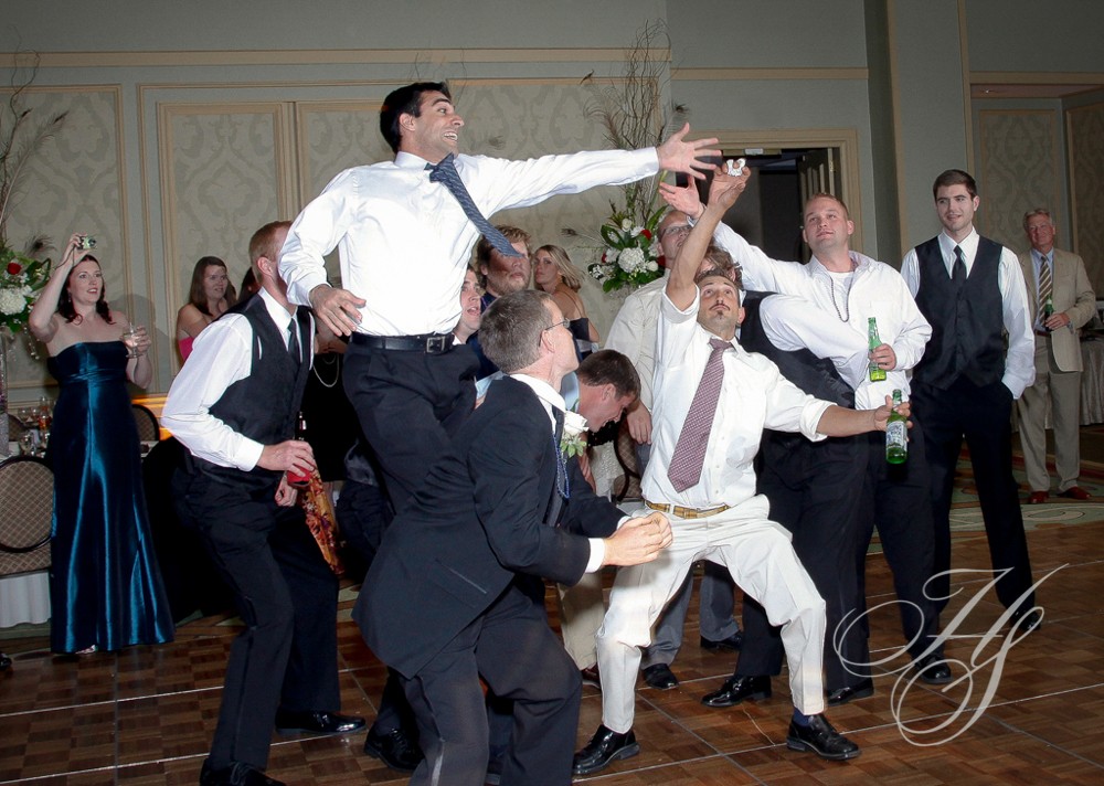 A group of men in suits and ties dancing.