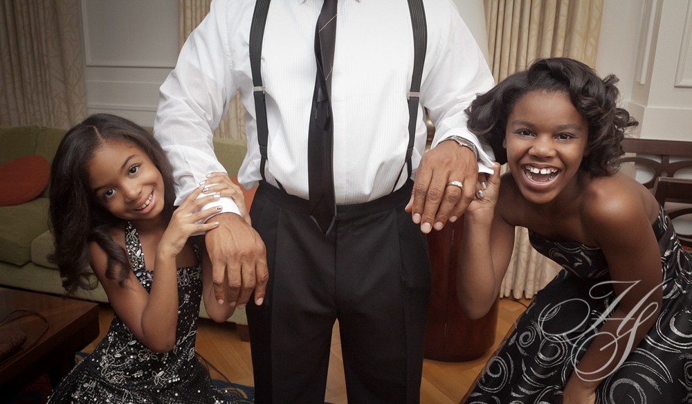 A man standing next to two women.