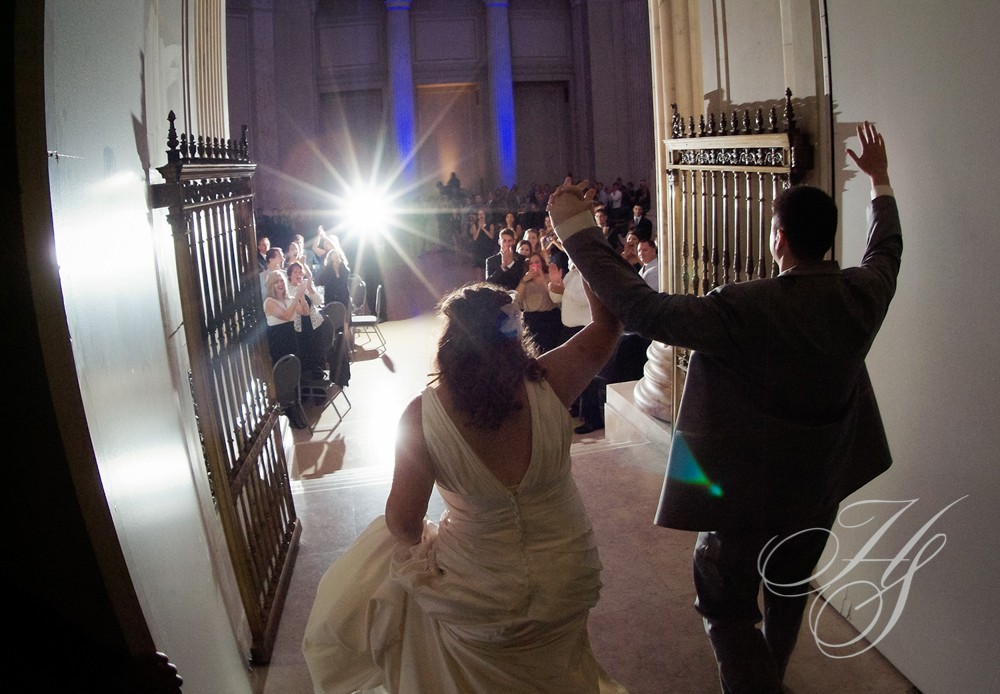 A bride and groom are dancing in front of the crowd.