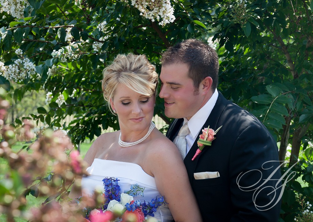 A bride and groom pose for the camera.