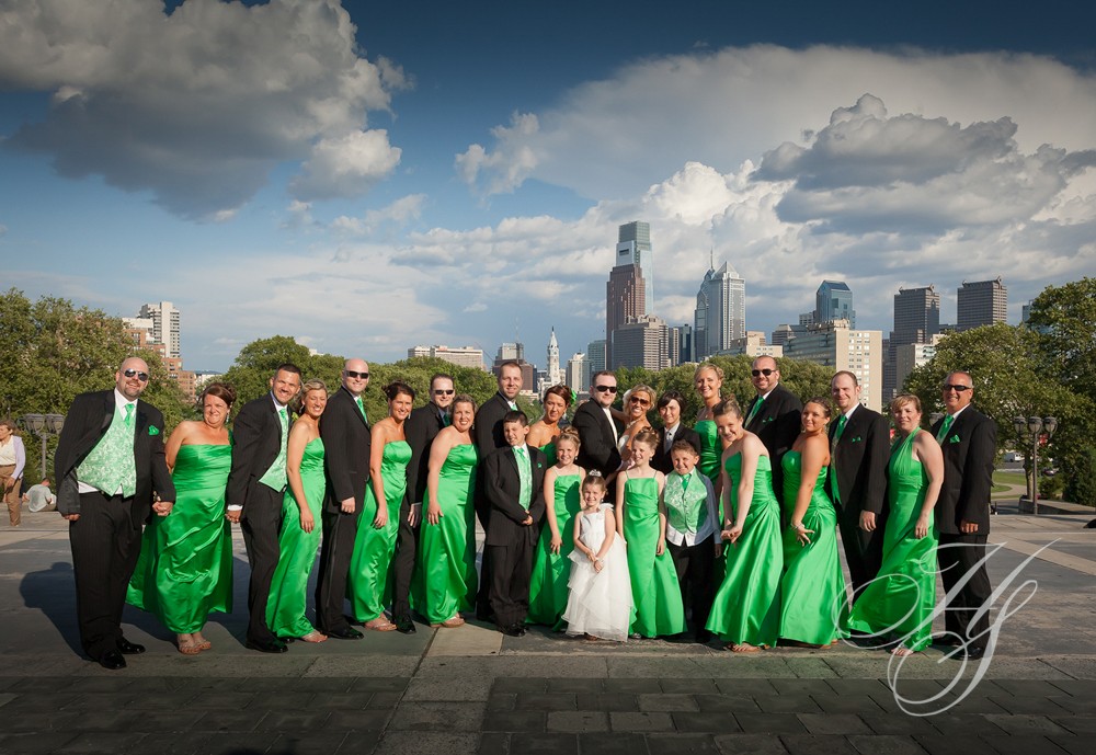 A group of people in green dresses posing for a picture.
