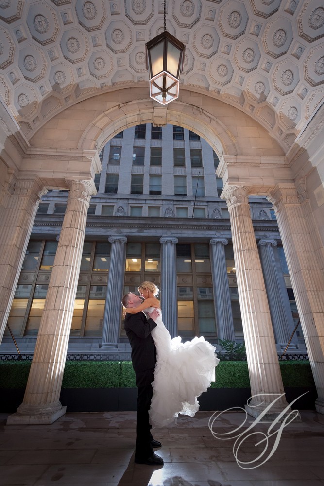 A bride and groom pose for their wedding picture.