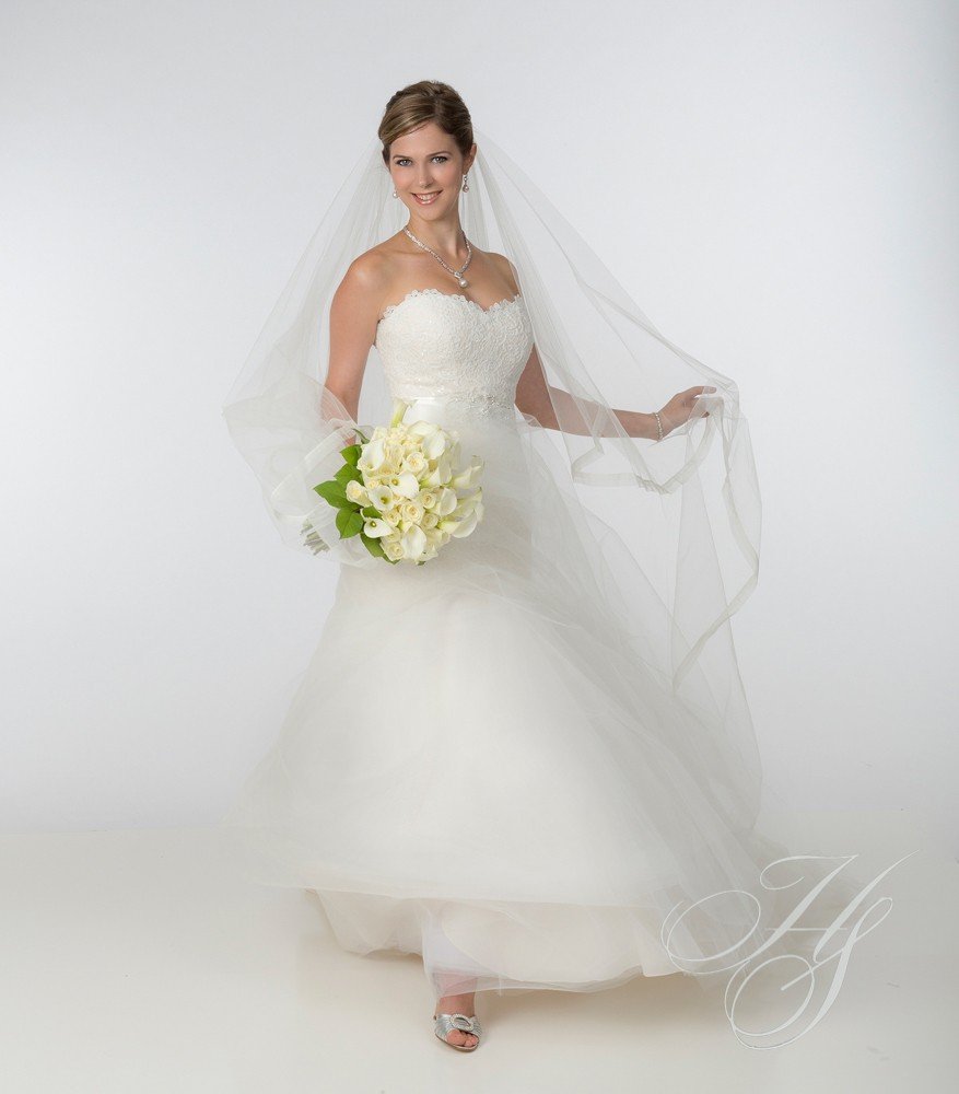 A bride in her wedding dress holding flowers