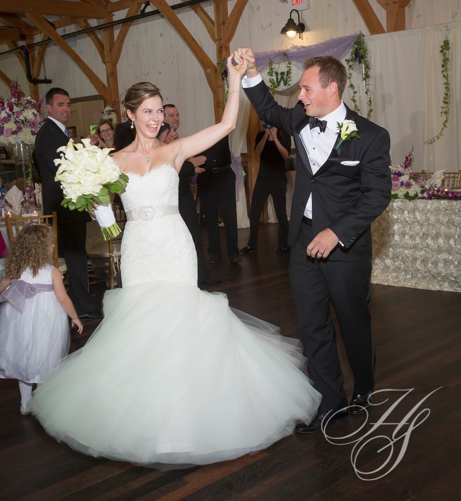 A bride and groom are dancing at their wedding.