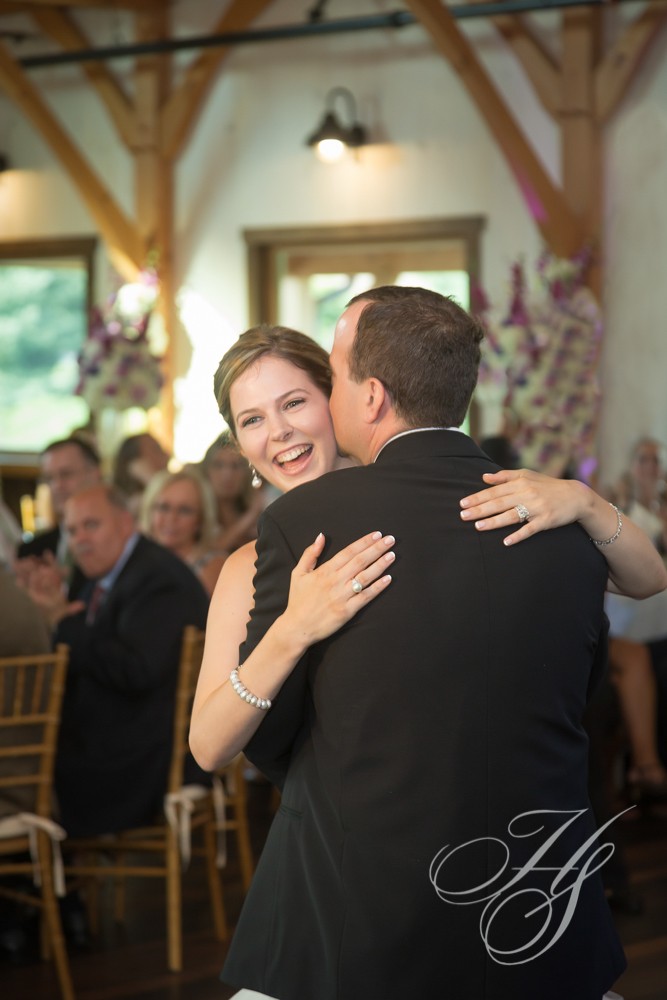 A man and woman hugging at their wedding.