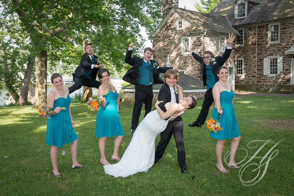 A group of people in formal wear posing for a picture.