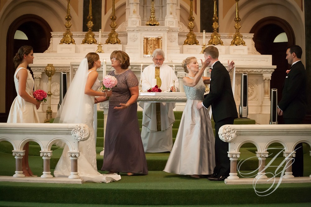 A couple getting married in front of the priest.