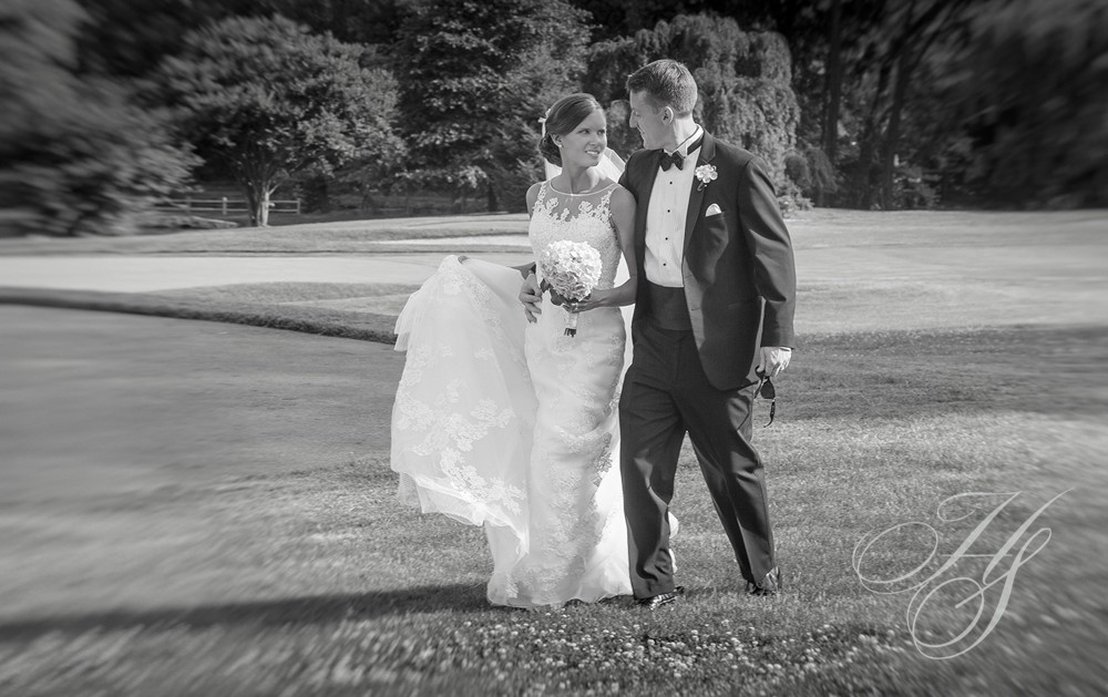 A bride and groom pose for the camera.