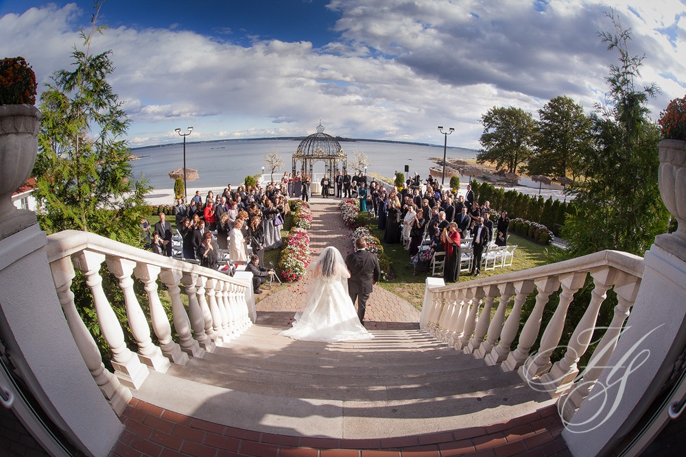 A bride and groom walking down the steps to their wedding.