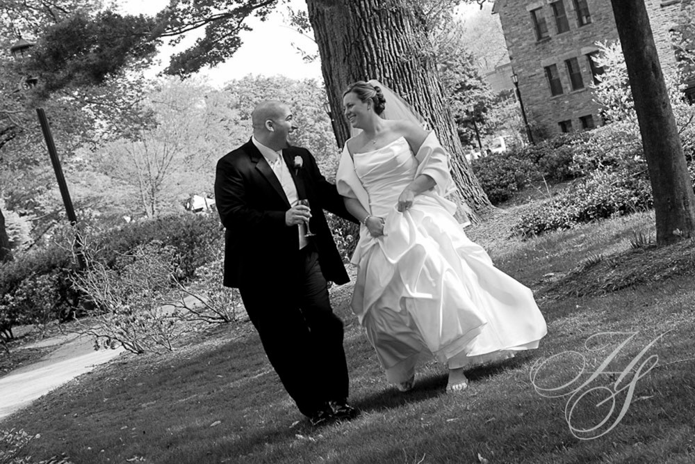 A man and woman walking in the grass.