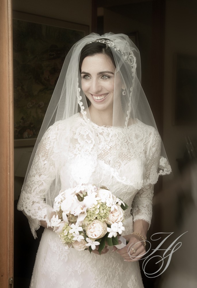 A bride in her wedding dress holding flowers