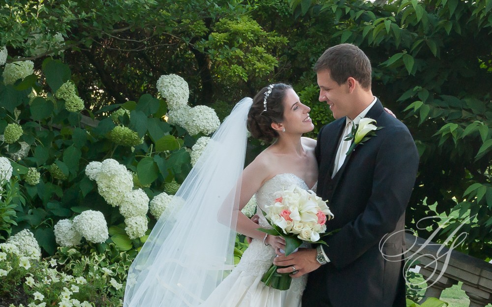 A bride and groom posing for a picture.