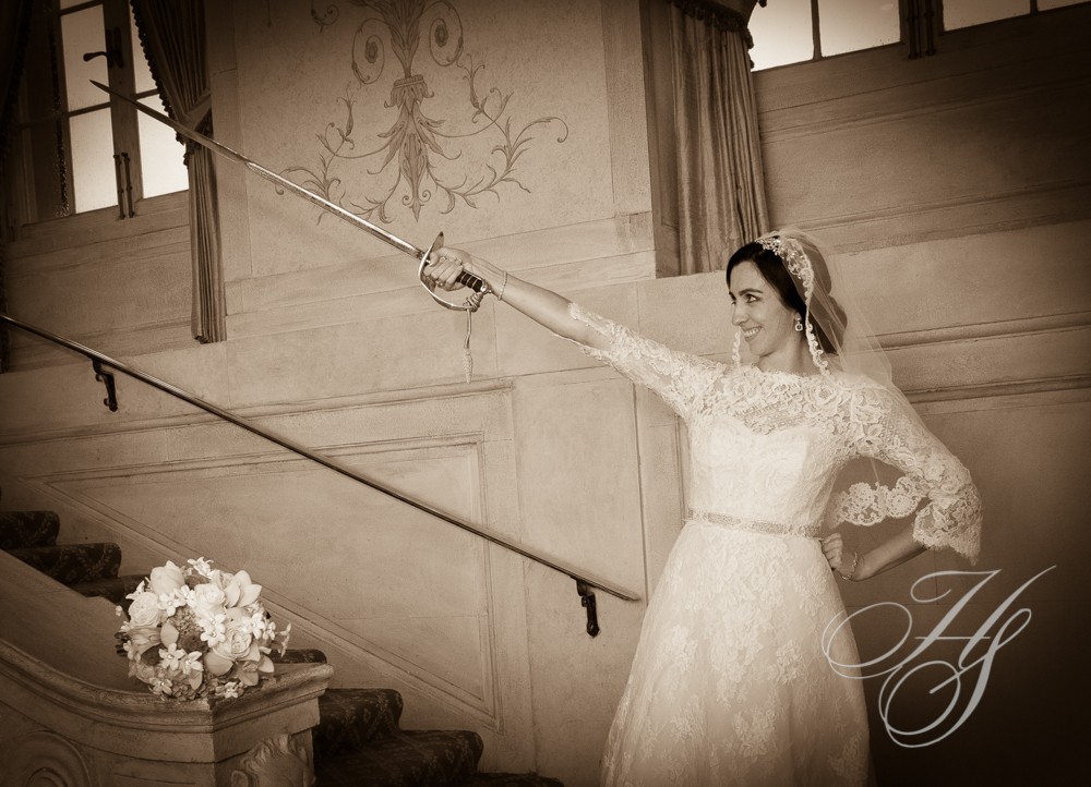 A bride holding onto the handle of her sword