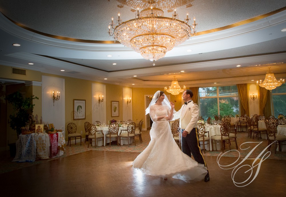 A bride and groom dance in the ballroom.