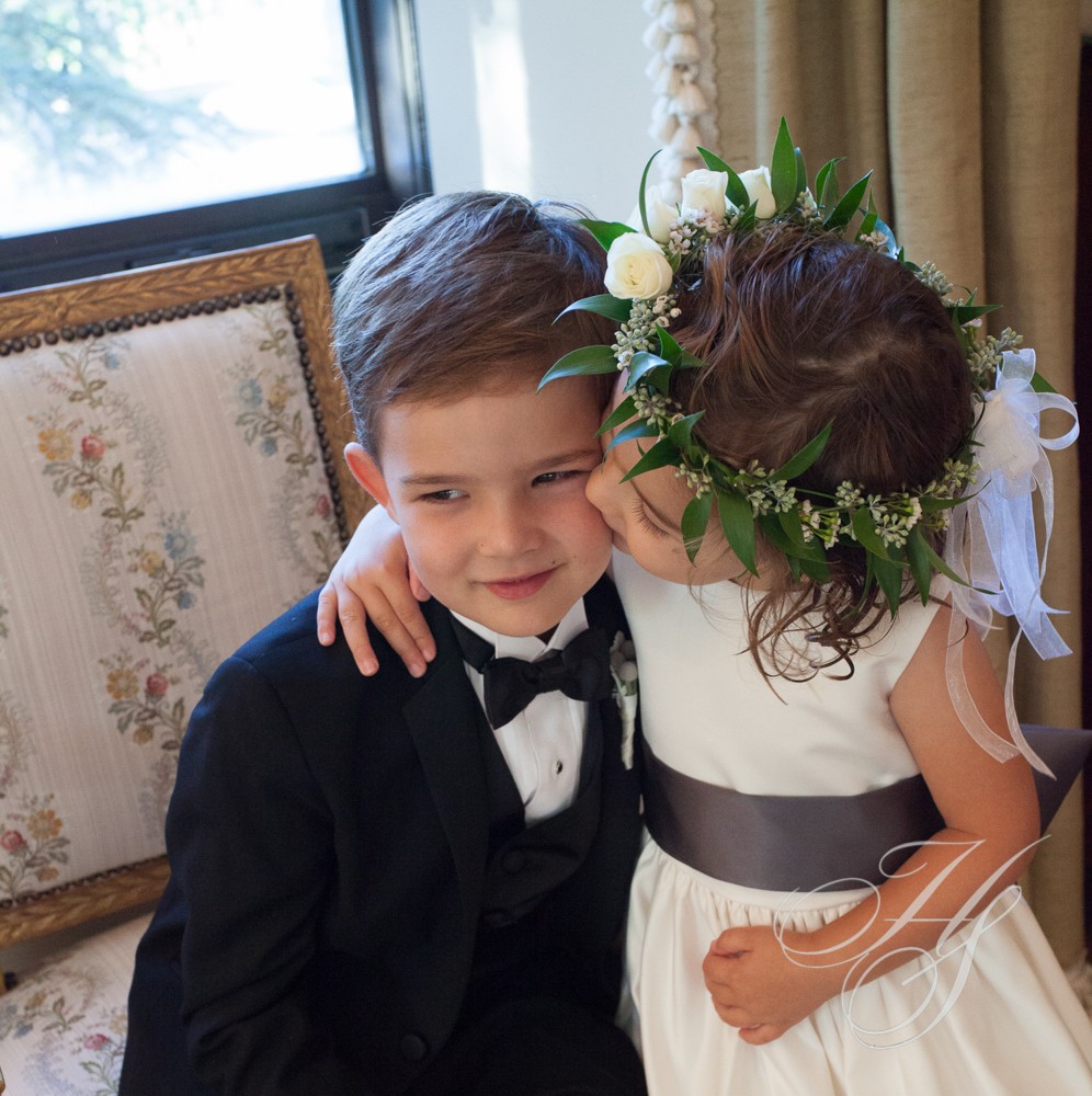 A young boy and girl are posing for the camera.