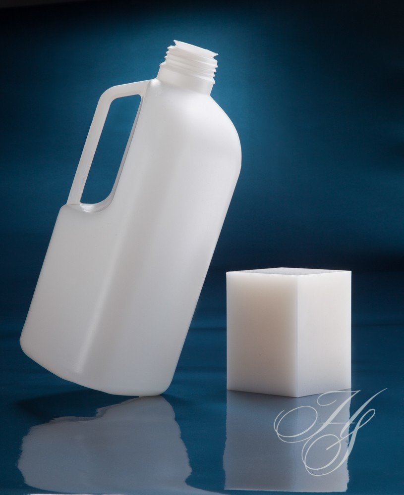 A bottle and cube are shown next to each other.
