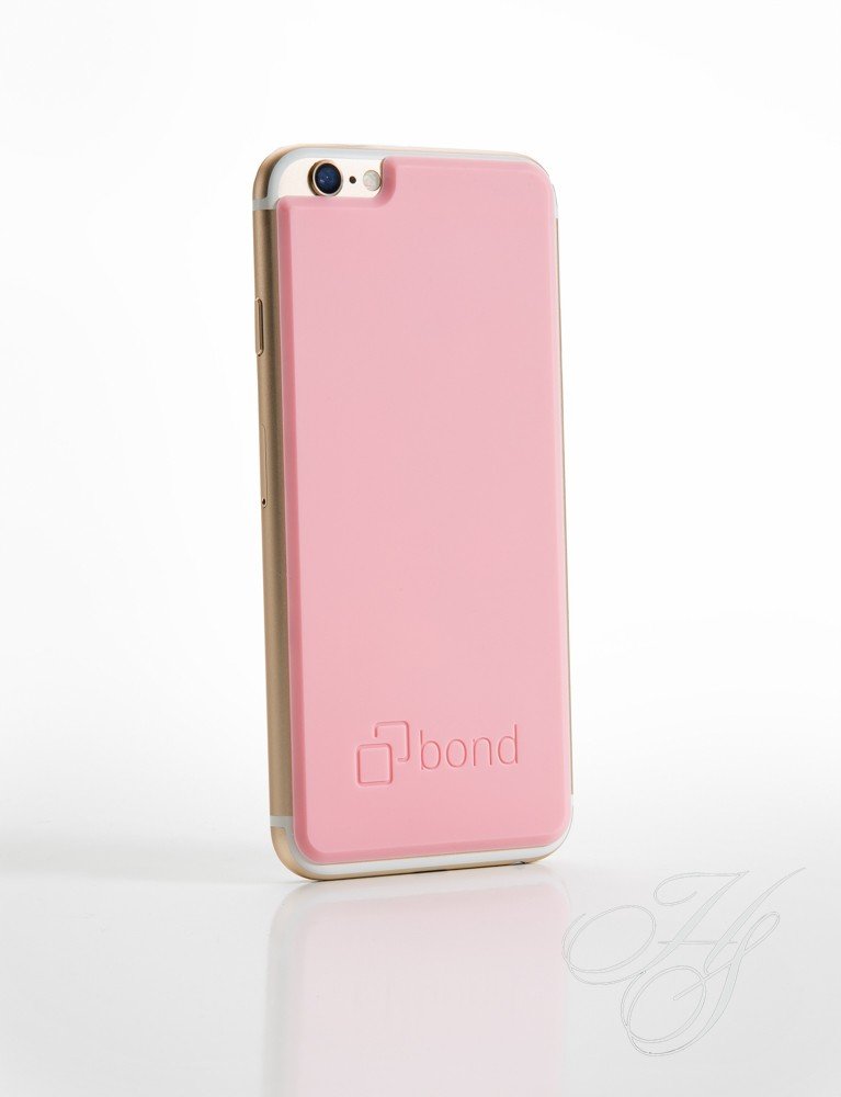 A pink phone case sitting on top of a table.