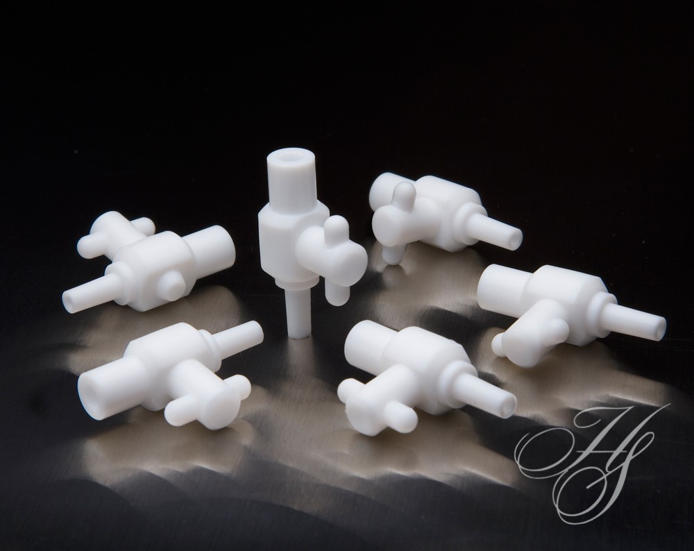 A group of white plastic valves sitting on top of a table.
