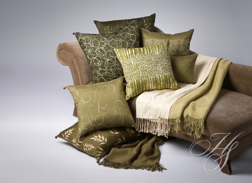 A couch with many pillows and blankets on it