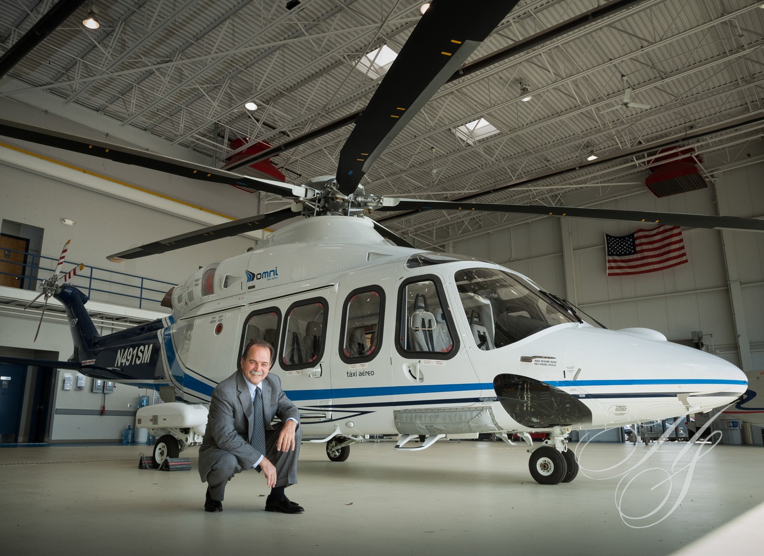 A man kneeling in front of an airplane.