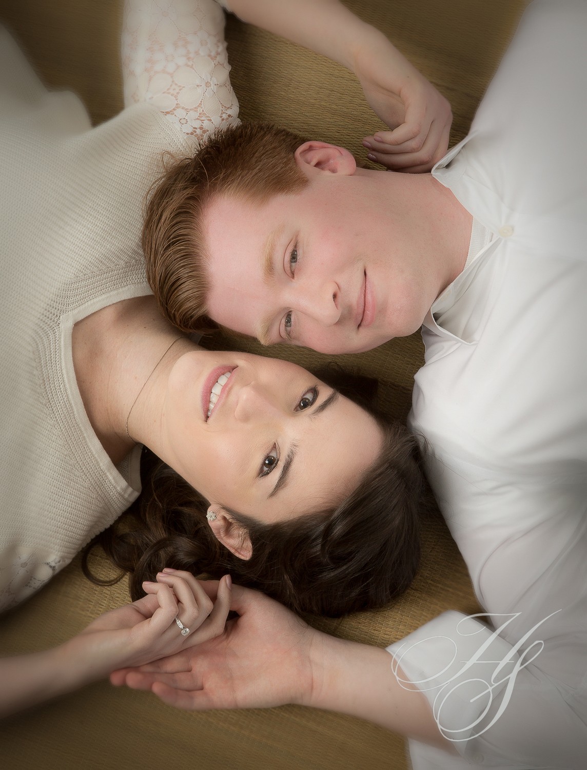 A man and woman laying on the ground.