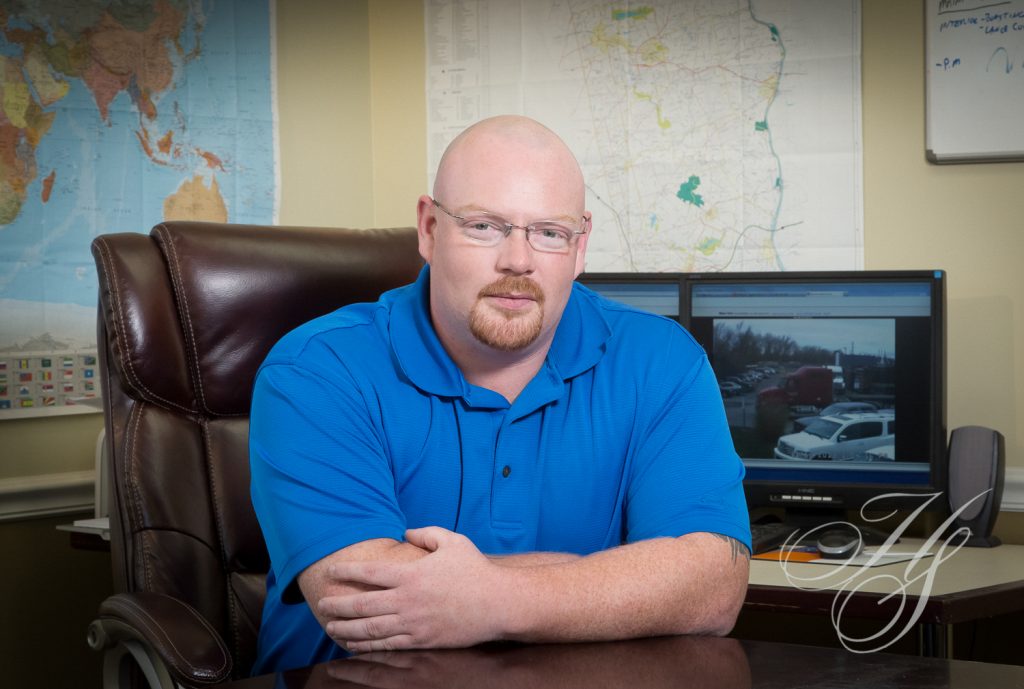 A man sitting at a desk in front of a map.