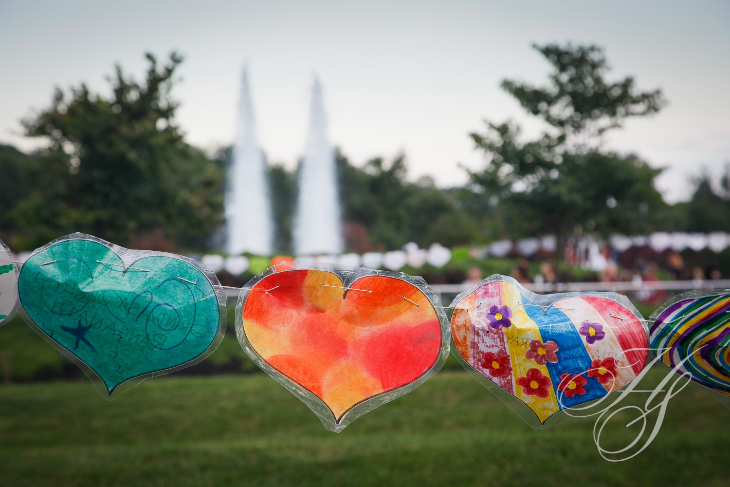 A group of balloons hanging on a line.
