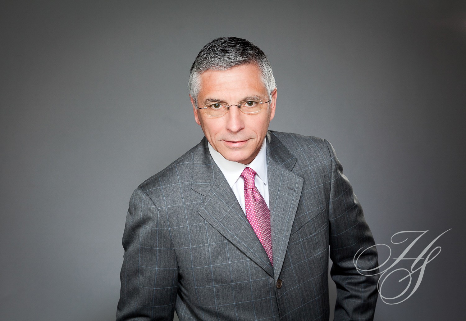 A man in a suit and tie standing up.