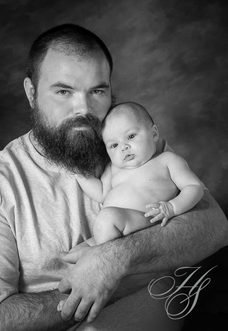 A man holding a baby in his arms.